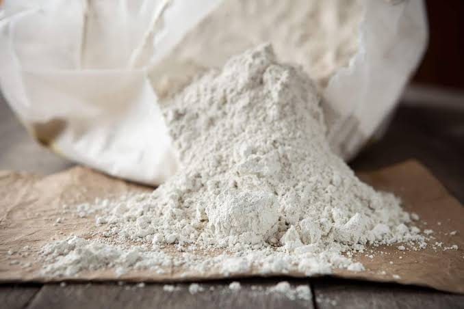 Diatomaceous earth powder spilling from a bag